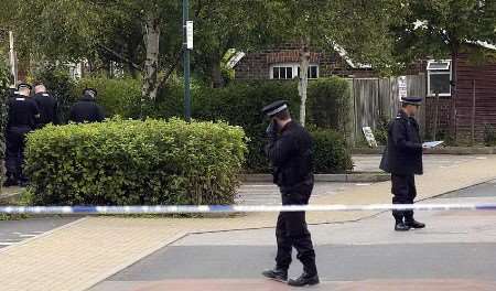 Police officers searching the area near the building society. Picture: JOHN WARDLEY