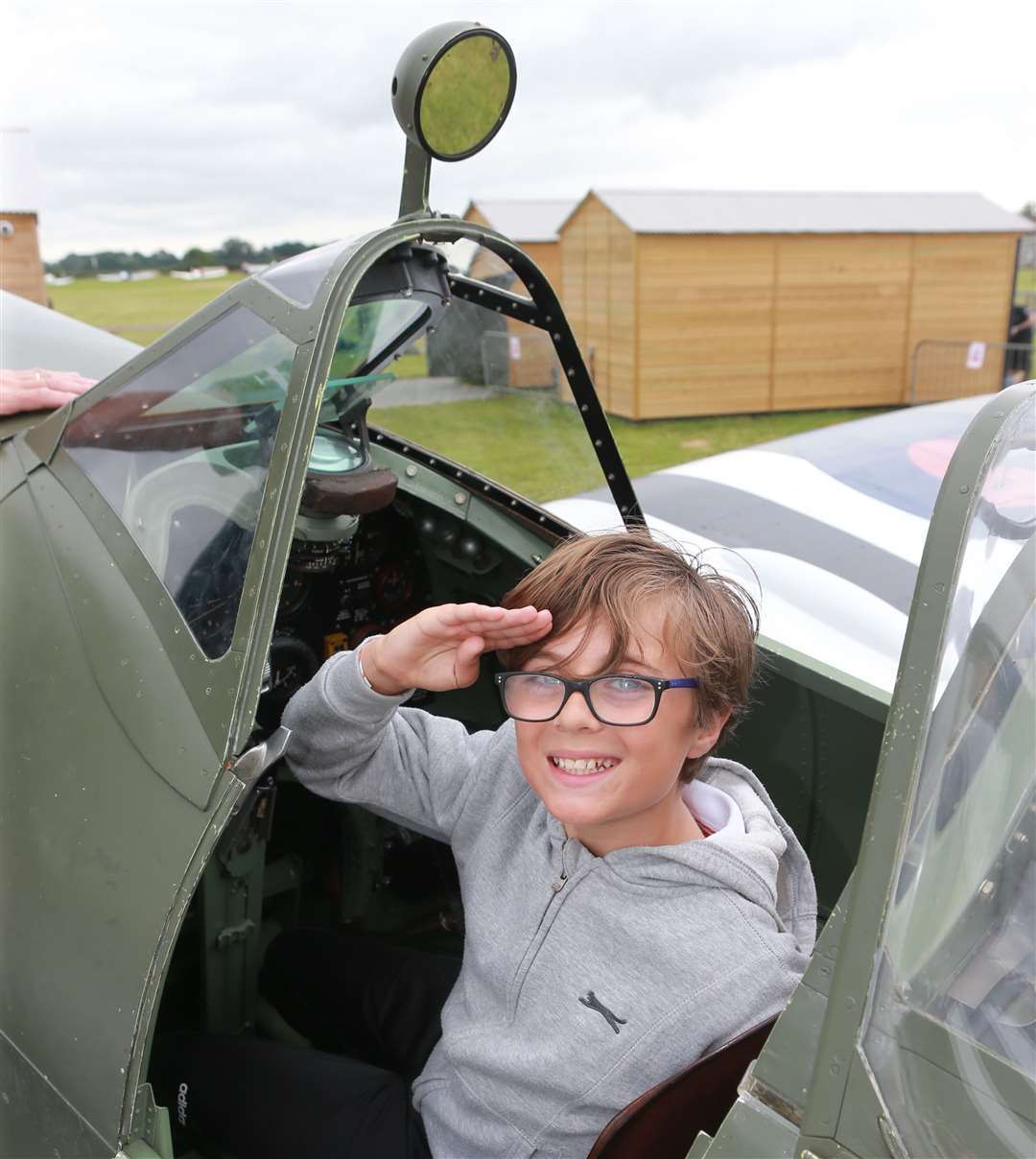 Oliver Douglas from Ashford sits in a Spitfire's cockpit during last year's show Picture: John Westhrop