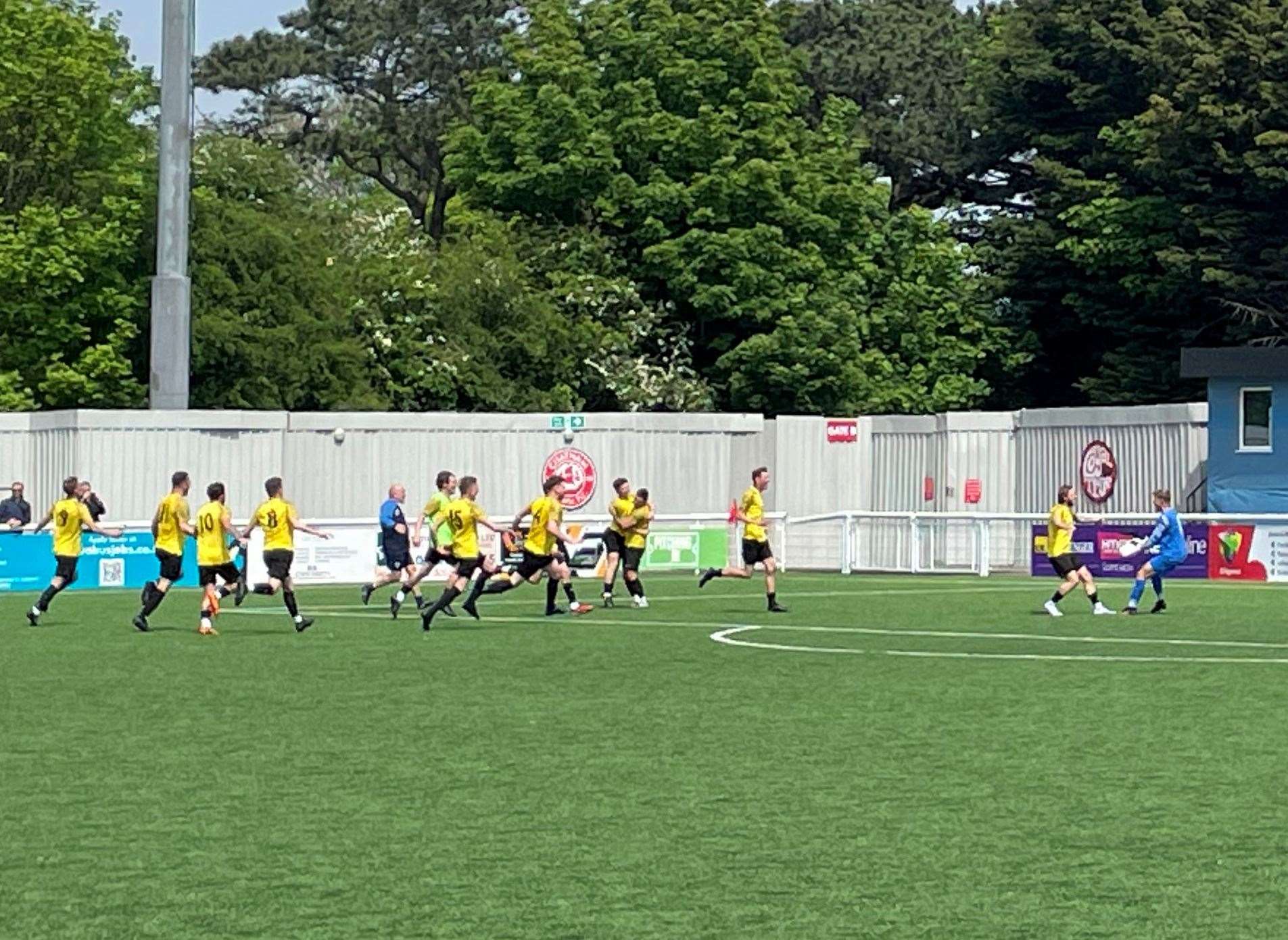 Goalkeeper Magnus Lewis congratulated by team-mates after his penalty heroics