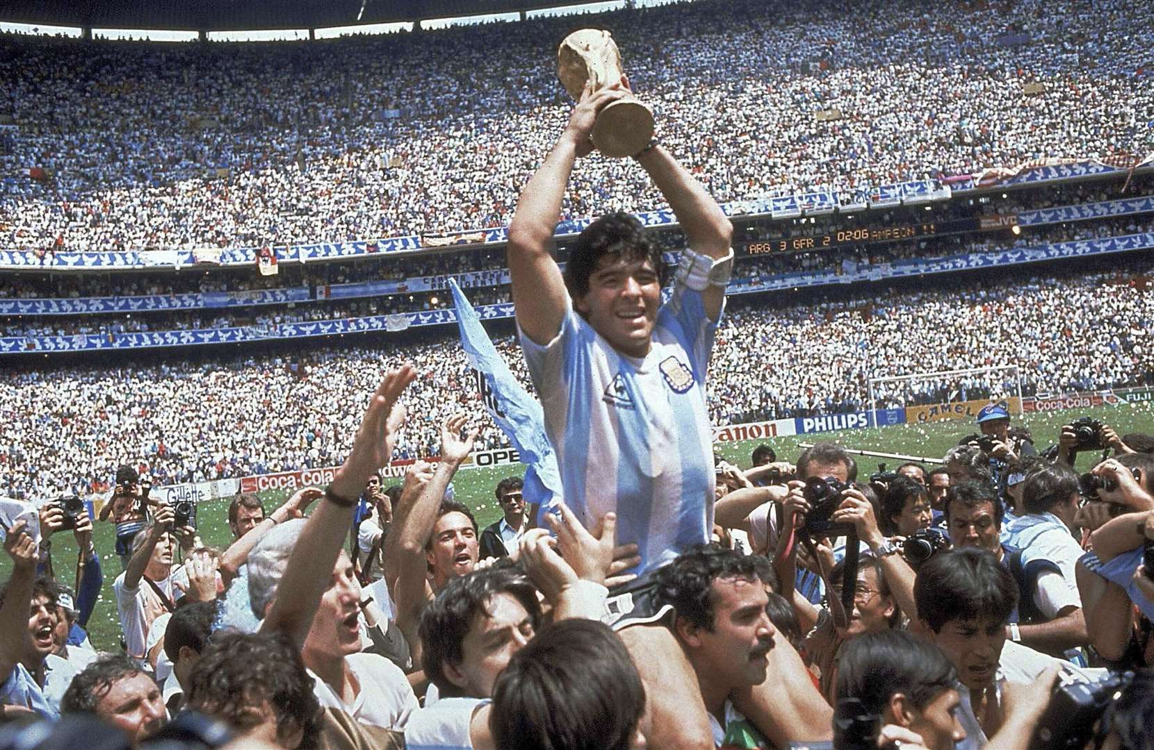 Diego Maradona holds up his team's trophy after Argentina's 3-2 victory over West Germany at the World Cup final In Mexico City Picture: AP Photo/Carlo Fumagalli, File