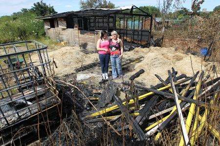 Ellesse Norris, 15, with her mother, Emma, right, in the ruins of their Aylesford stables after the fire