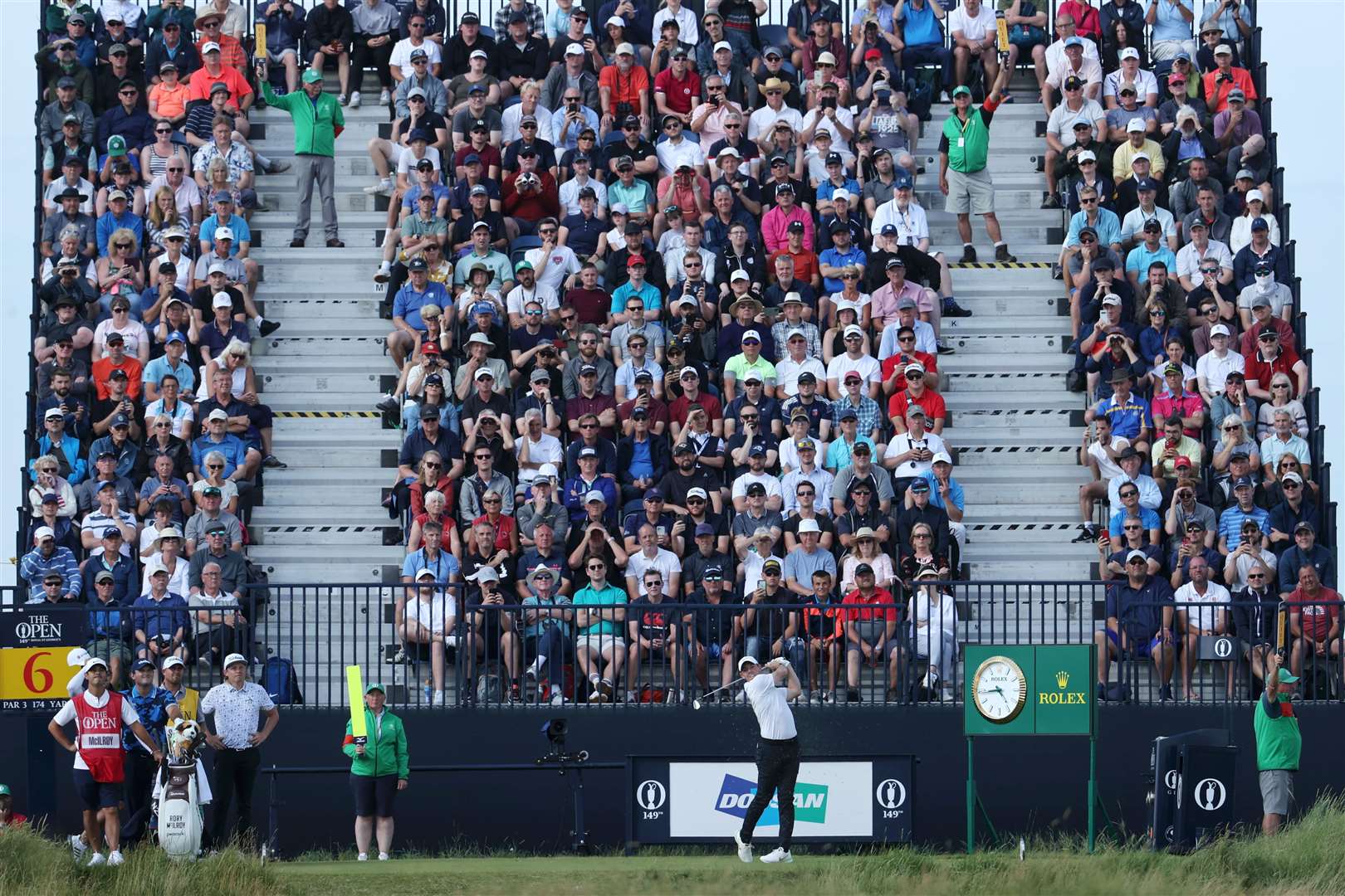 Packed galleries watch on as Rory McIlroy tees off on the sixth. Picture: The R&A