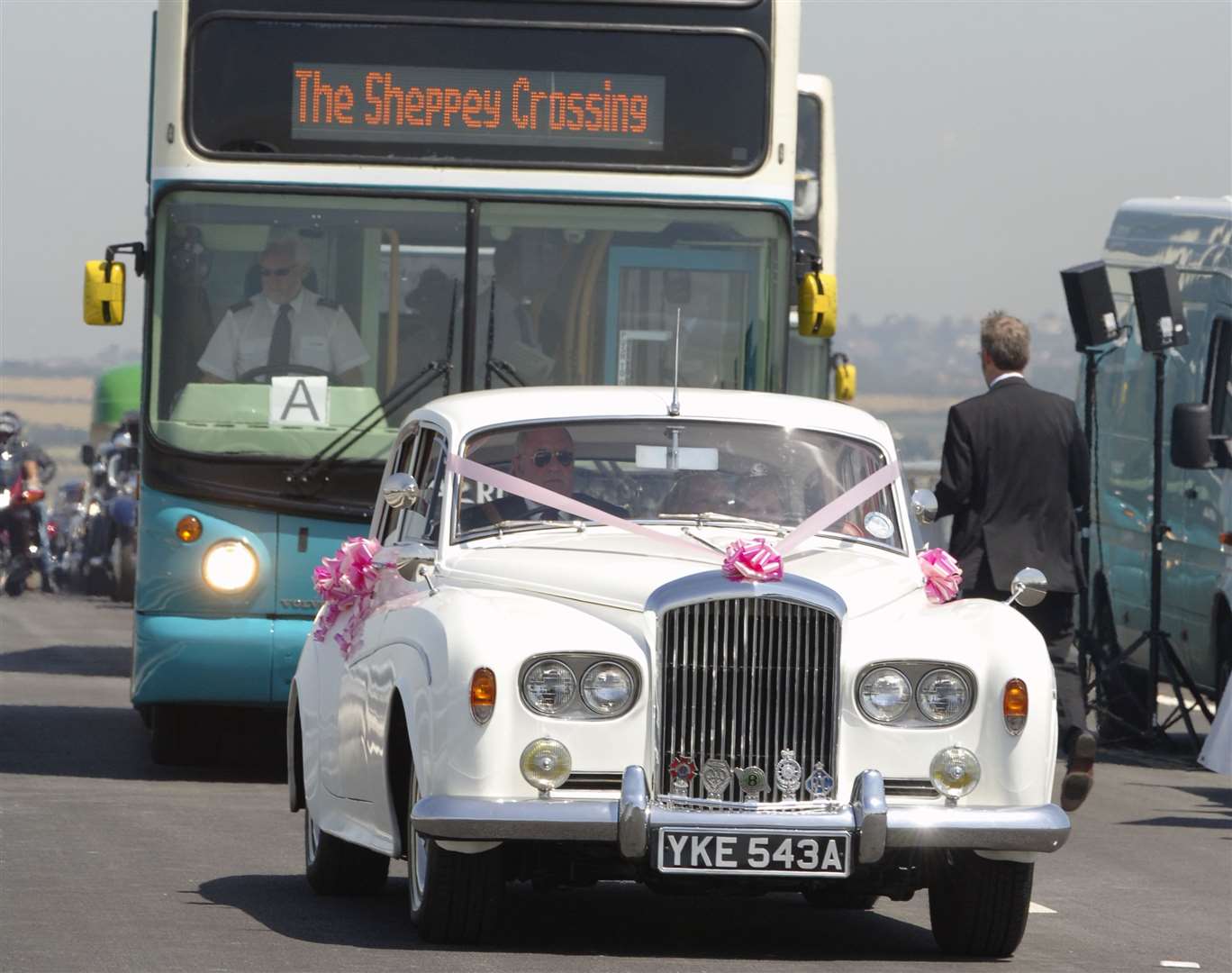 The car of bride Kristina Wylie and her dad James crossing the bridge for the first time, followed by a bus load of guests