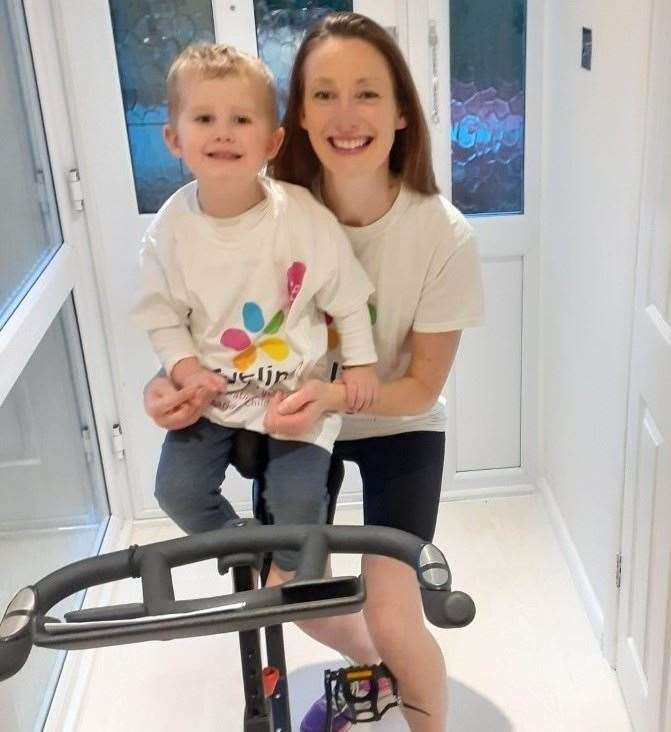 Caroline May with her son Arthur as she prepares to cycle 680 miles on a static bike.