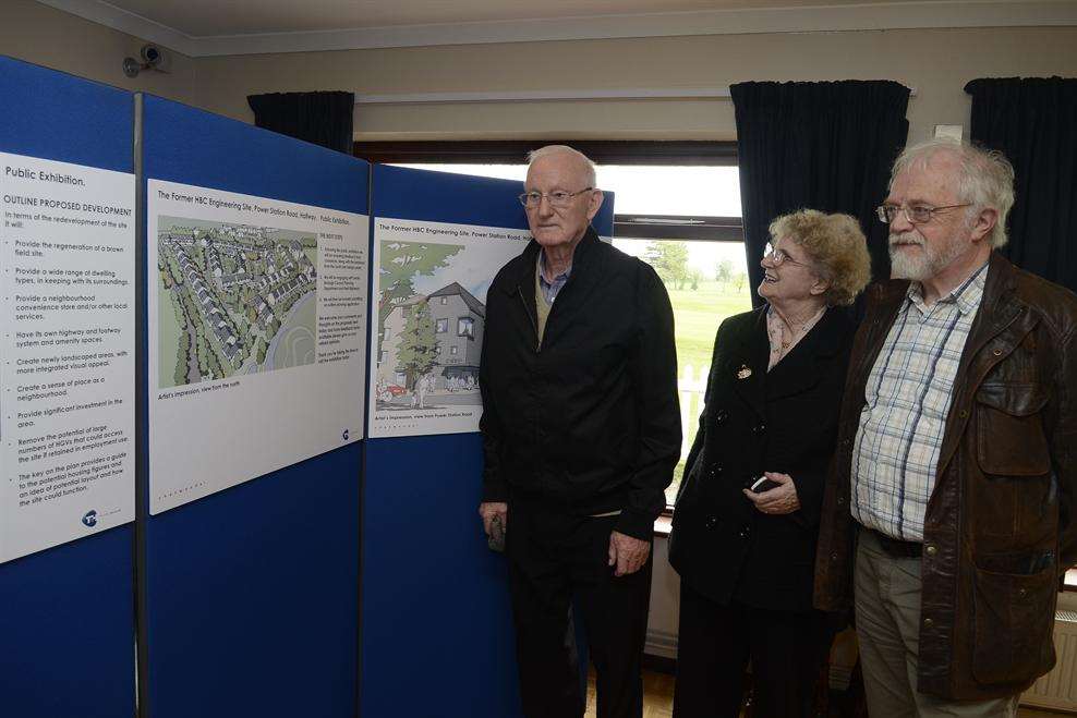 Residents Raymond and Georgina Reveley and Paul Hayes of the Halfway Houses Residents' Association examine the plans for the new housing development
