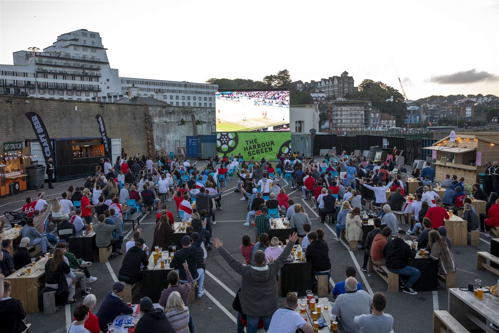 Fans watching the Euro 2020 semi final match between England and Denmark on the outdoor screen at Folkestone Harbour Arm. Picture: Andy Aitchison