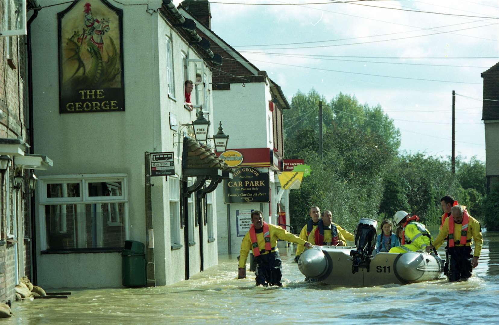 The fire service using inflatable to rescue residents from the floods in Maidstone.