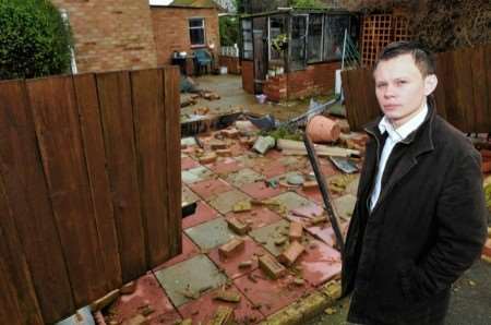 Dan Pyke in front of the damaged front garden
