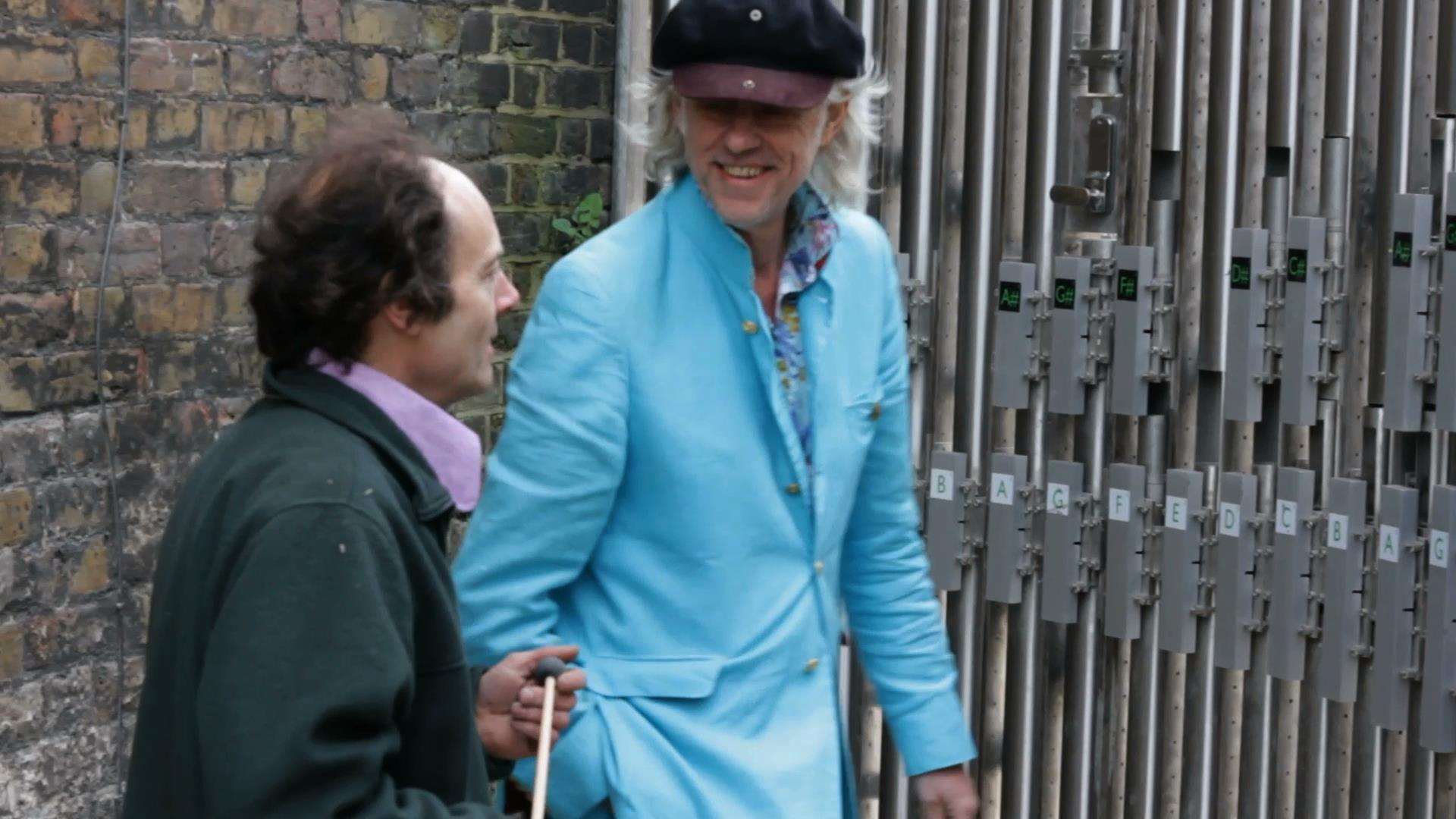 Bob Geldof, with sculptor Henry Dagg, at the musical gates