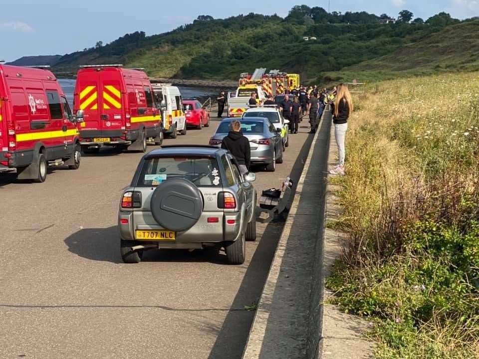People watch on at The Leas in Minster as emergency services deal with reports of a person falling from a cliff. Picture: Douglas Ingram