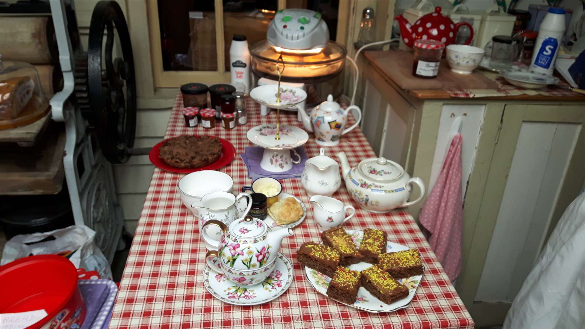 The kitchen table laid for cream teas at the Cottage of Curiosities in Rose Street, Sheerness