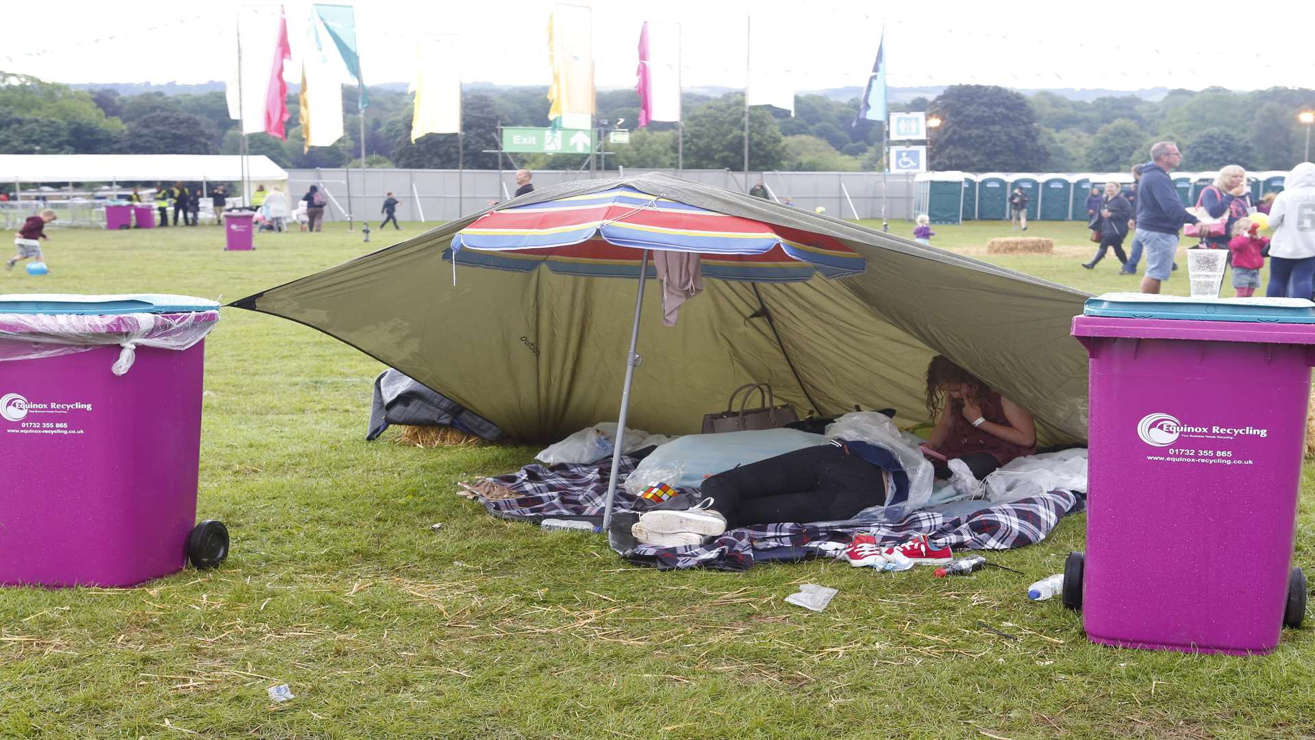 Some festival goers resorted to makeshift shelters as the weather turned on Saturday