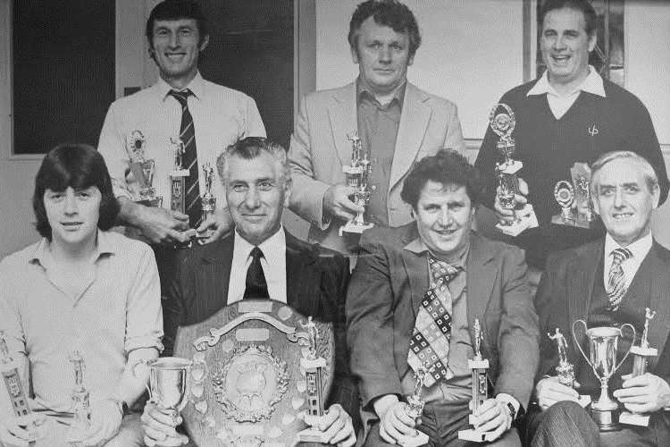Percy Brown, sitting second from left, holding one of the darts shields he won