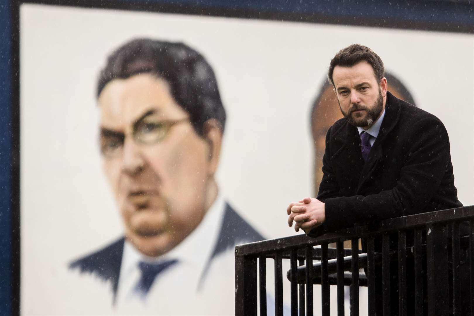 SDLP leader Colum Eastwood close to a painted mural of former SDLP John Hume in the Bogside area of Derry City (Liam McBurney/PA)