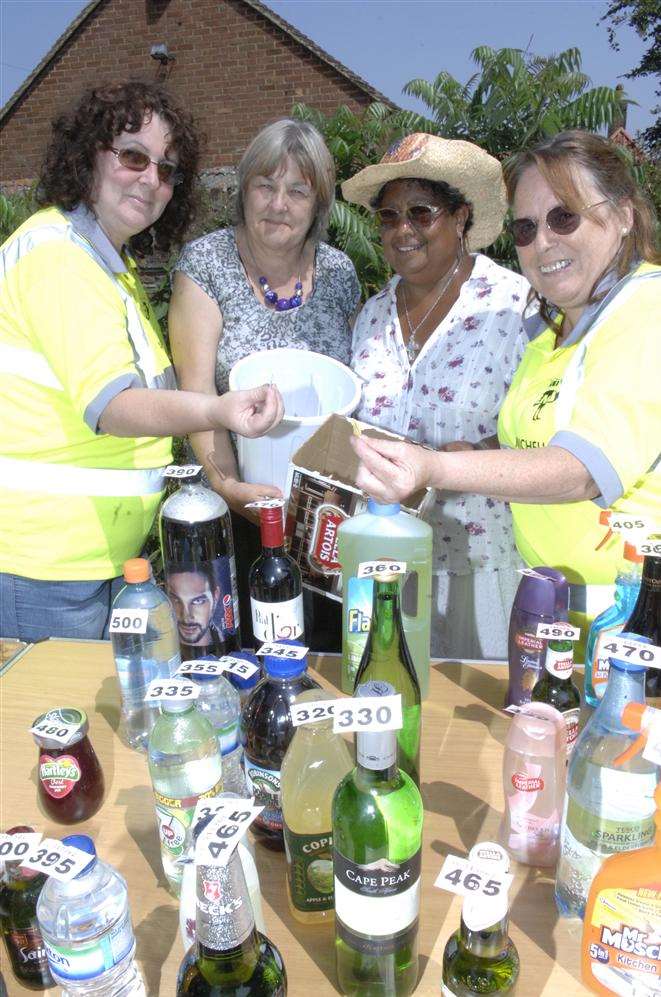Dawn Frost, left, and Michelle O'Neill right have a go on the tombola run by Angela Morley and Gloria Williams at the Minster Village Fayre