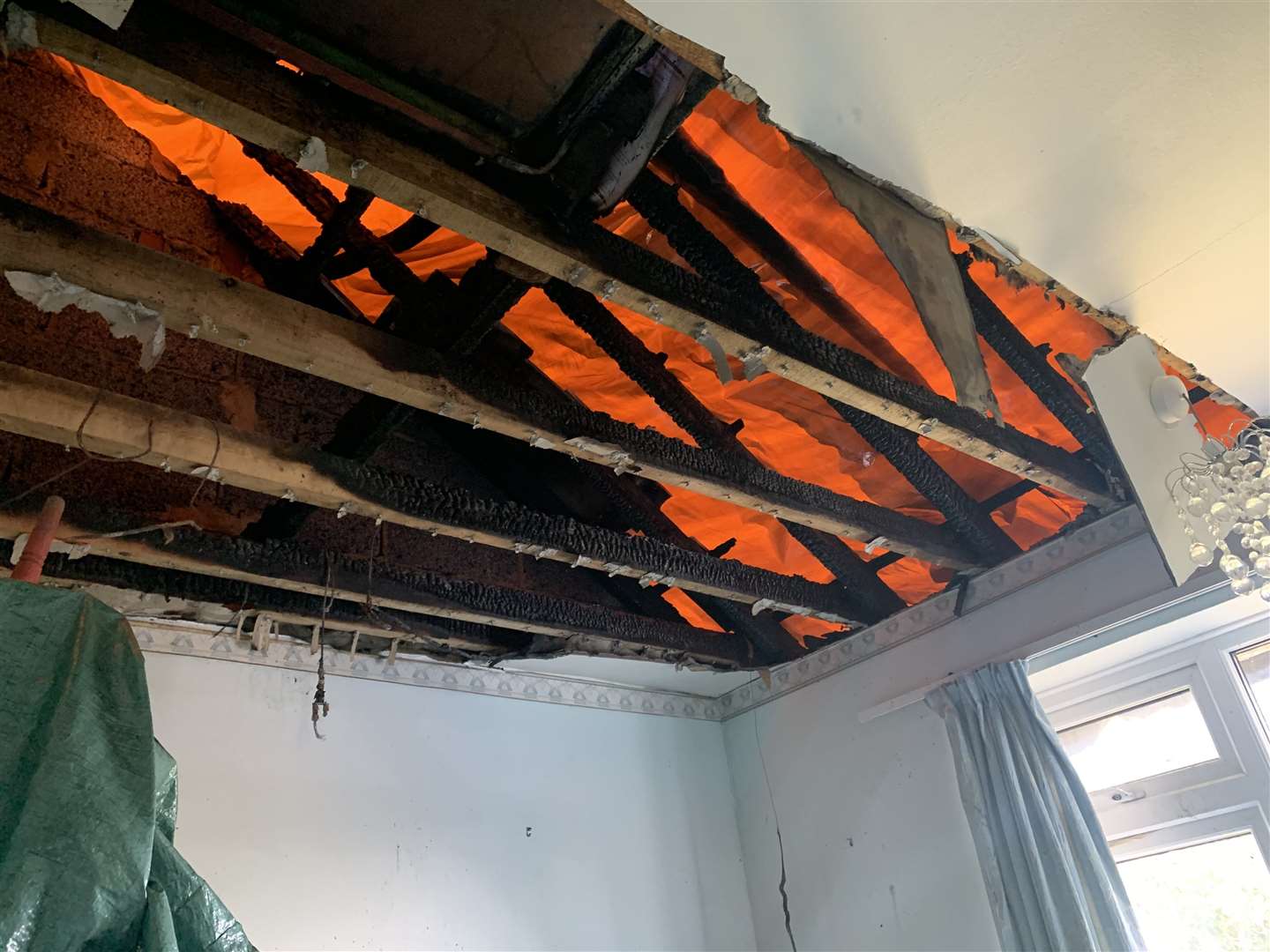 The hole in the roof of an upstairs bedroom caused by the lightning strike