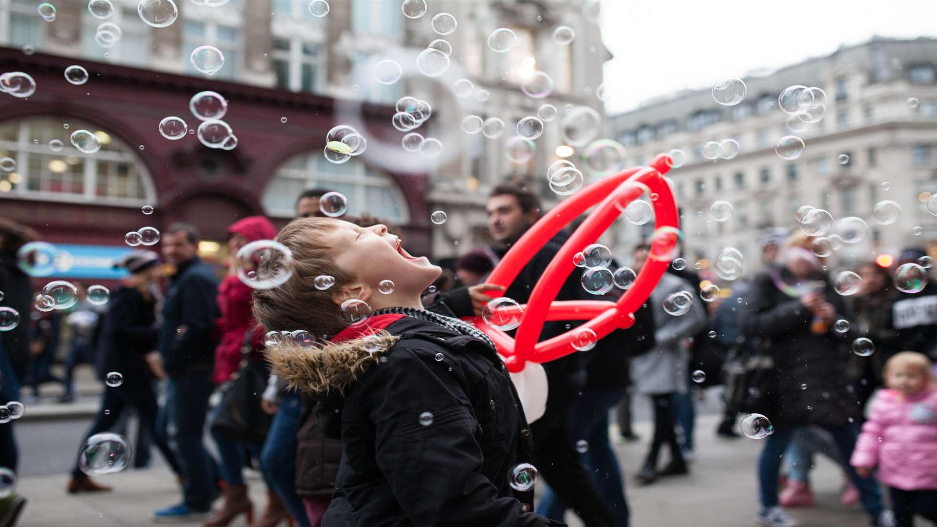 Max Chester, seven, eats edible bubbles at the Oxford Street lights switch-on