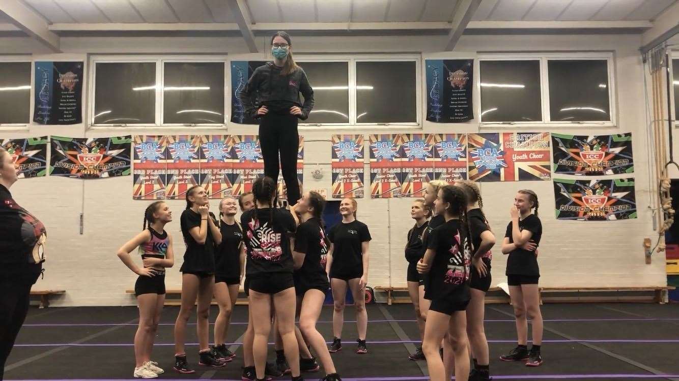 Alex being a flyer at the top of the successful stunt
