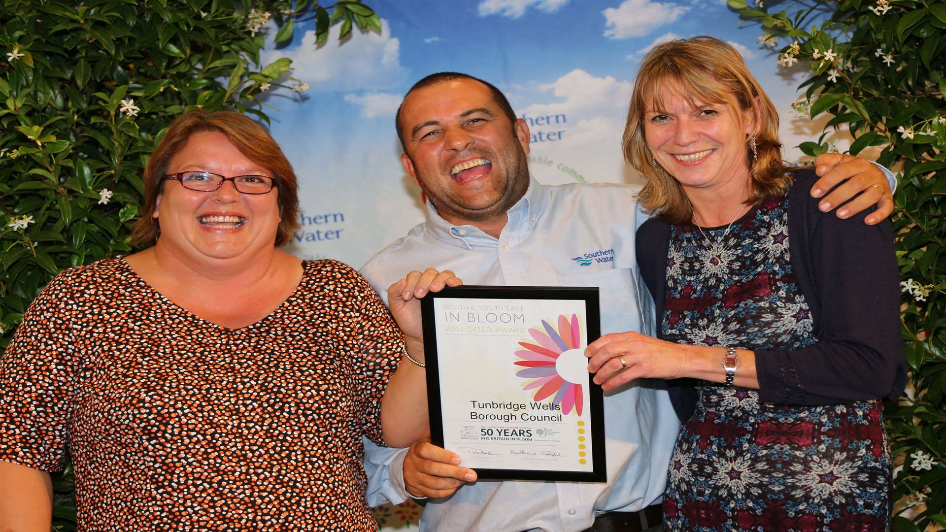 Sharon Carter and Helen Timms from TWBC collecting the award for large town from celebrity gardener Chris Collins