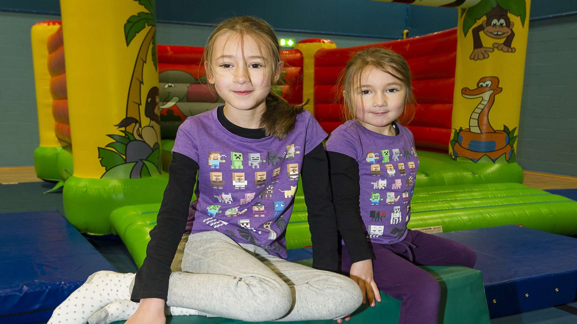 Evie Hayward, 8, and Alice Hayward, 5, and the bouncy castle in the sports hall.