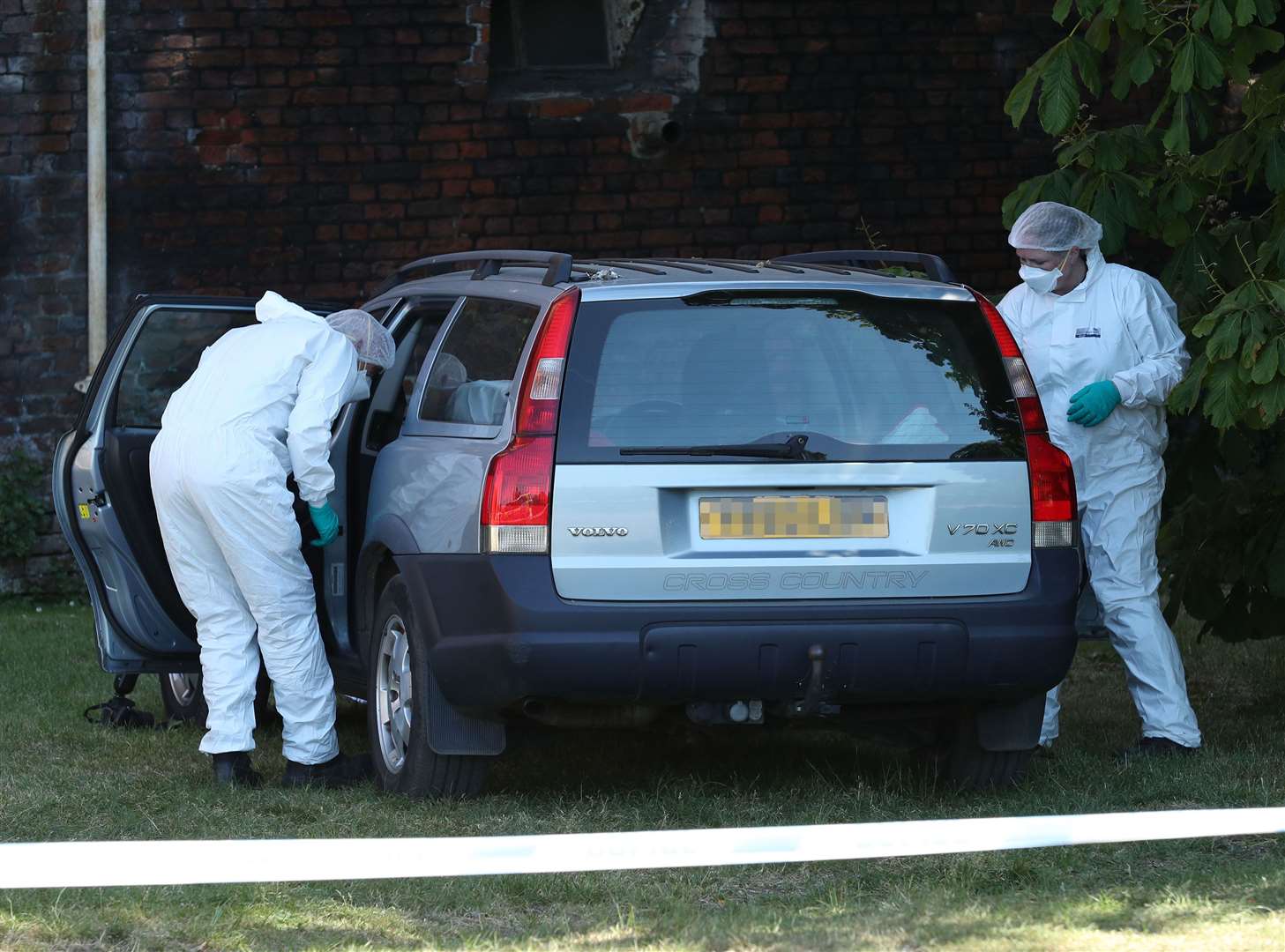 Police forensic officers search a car in the grounds of Lullingstone Castle in Eynsford, Kent (Yui Mok/PA)
