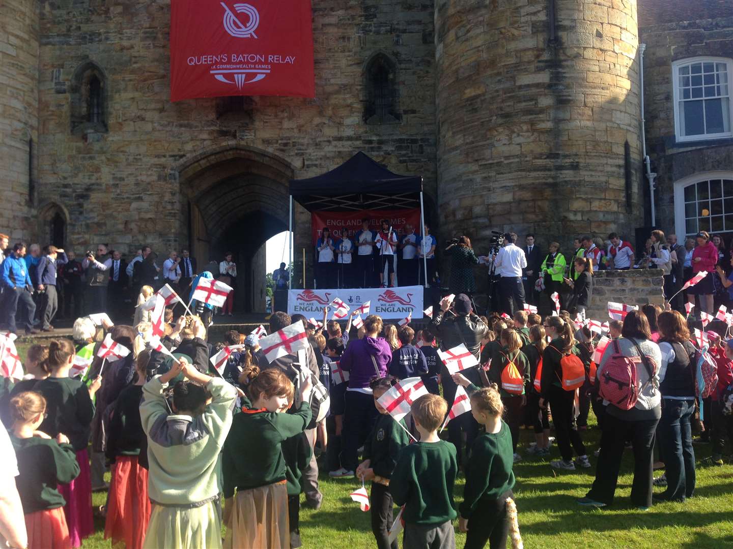 Pupils wave flags as the baton heads to Tonbridge Castle