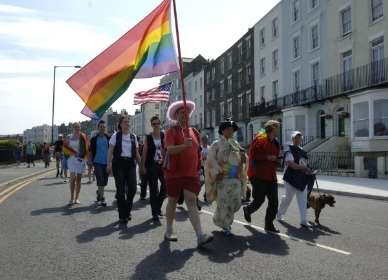 The rainbow flag leads the way for thousands of supporters