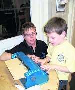 Daniel using his old Perkins Brailler with mum Paula Gunnell