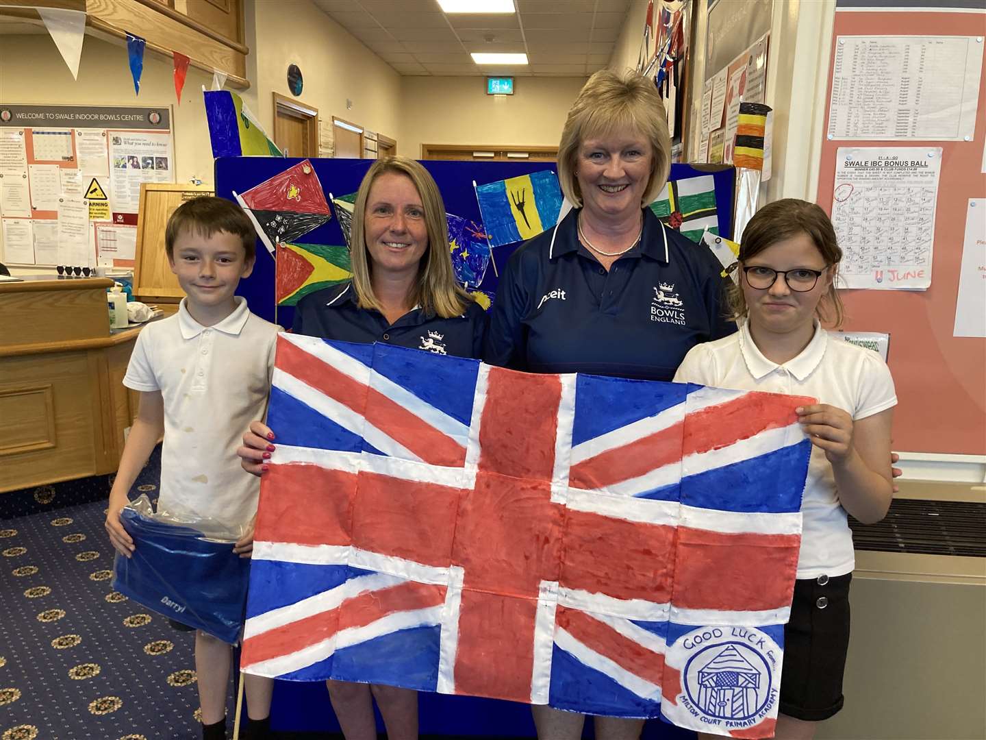 Children from the Milton Court Primary Academy with Sandy Hazell and Michelle White with the flag they had made