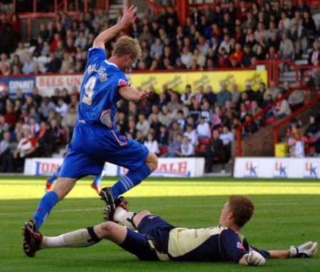 Gary Mulligan is brought down by Brentford keeper Clark Masters for the penalty. Picture: BARRY GOODWIN