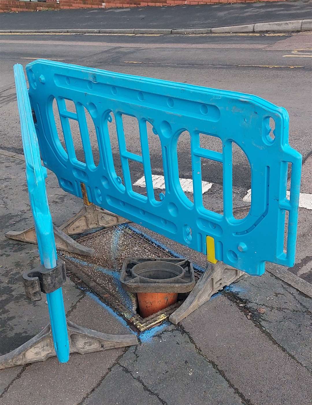 A barrier around a hole in Greggs Wood Road