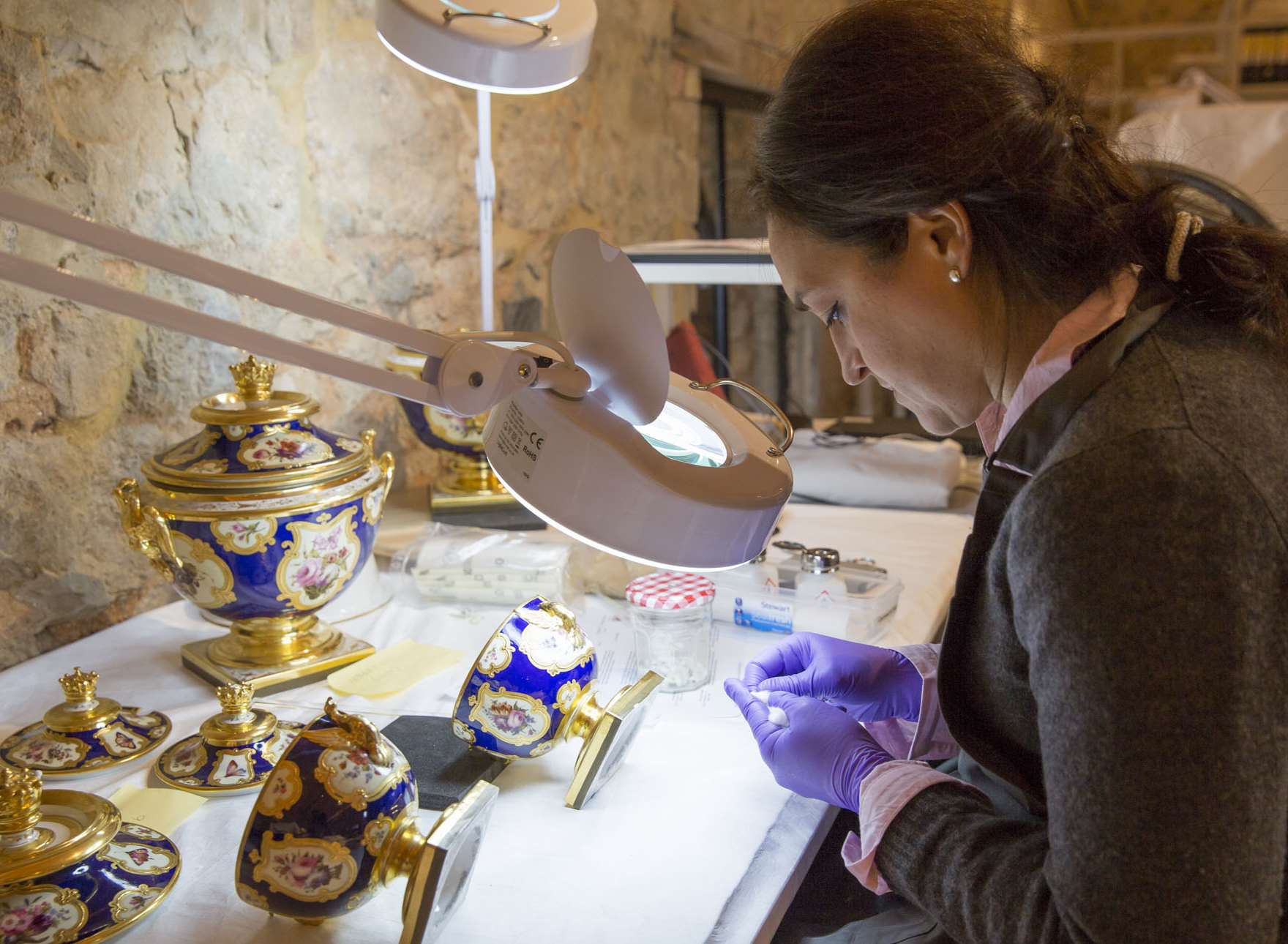 Conservator Carmen Video conserving a garniture of Flight & Barr & Barr porcelain from the Ballroom at Knole Picture: National Trust, James Dobson