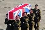 The body of Colour Sergeant Krishna Dura is carried by colleagues after landing at RAF Lyneham