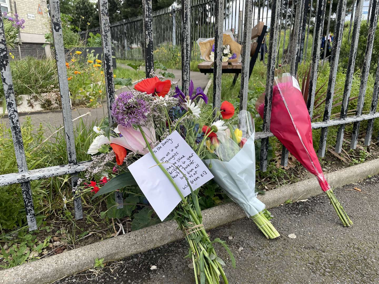 Floral tributes and messages of condolence were left outside the apartment block following the incident (Samuel Montgomery/PA)