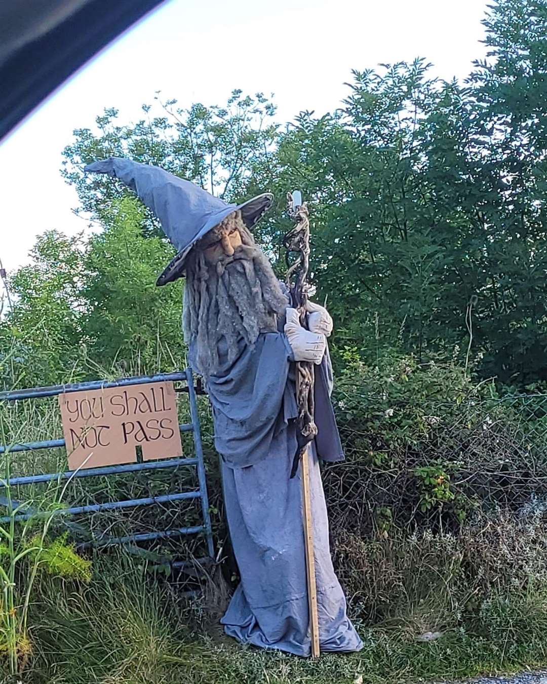 A scarecrow of Gandalf from the Lord Of The Rings next to a gate (Louise Henson/PA)