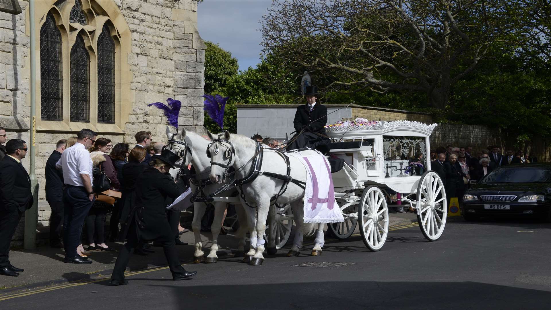 Two white horses pulled the hearse