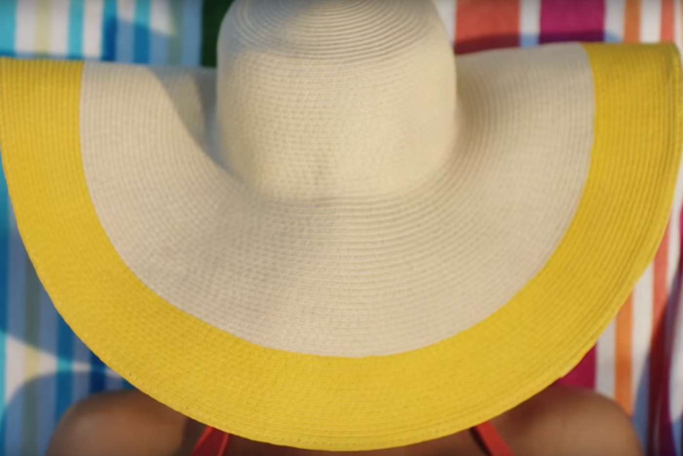 The 30-second ad shows a woman in a floppy sun hat