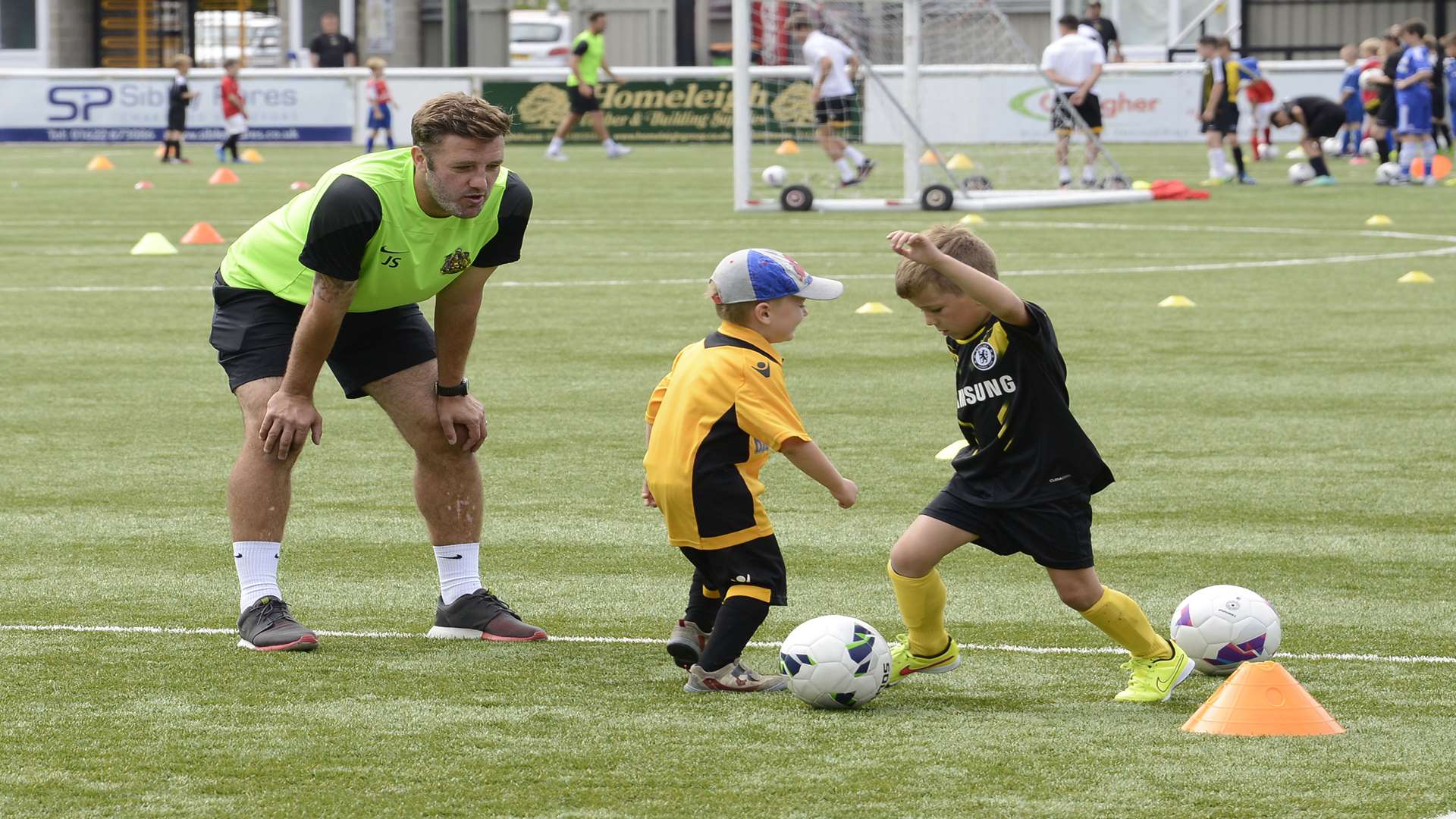 Maidstone manager Jay Saunders coaches youngsters at the club's summer soccer school Picture: Paul Amos