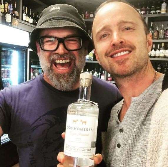 Aaron Paul poses with The Offy manager Ross Bell and a bottle of the actor's mezcal, Dos Hombres. Pic: Ross Bell