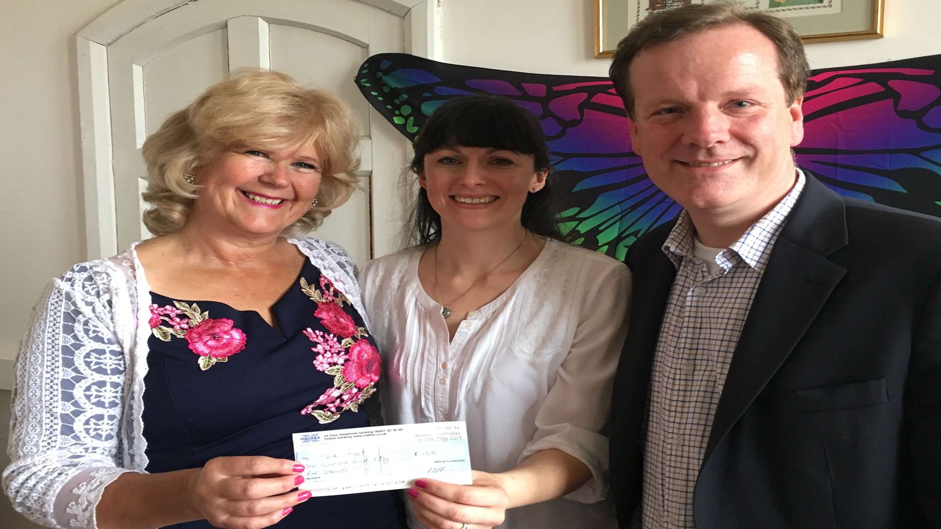 Mental heath campaigner Tracy Carr recieves a donation from Maria Flanagan, pictured with Conservative candidate Charlie Elphicke