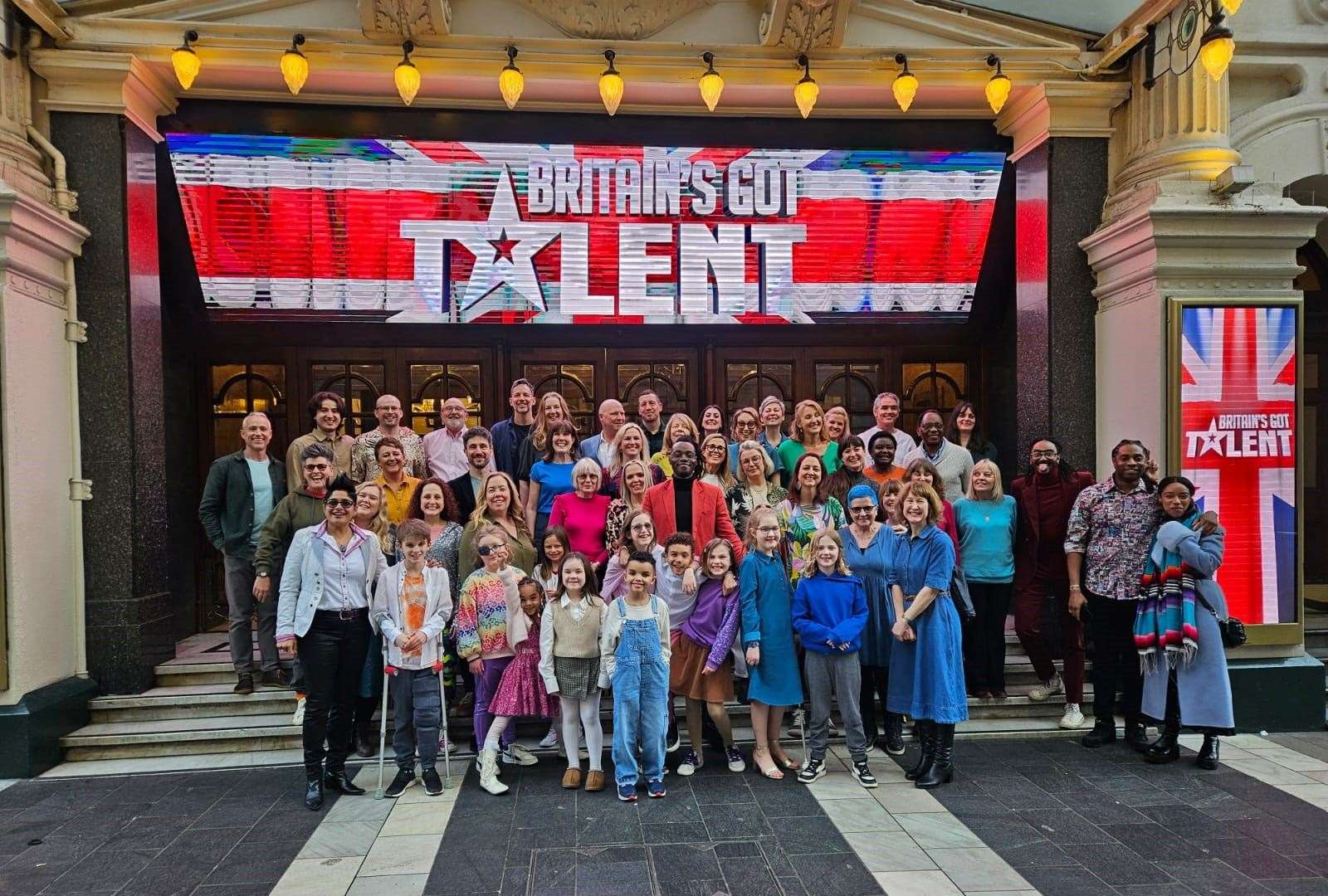 The choir outside the theatre after recording their BGT audition - Samuel is front left on crutches