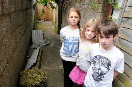 Jacey Birch, 10, Alicia Birch, six, and Matthew Judge, 10, in the Gillingham alley containing dangerous asbestos