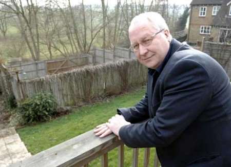 Campaign leader Bill Wayland with the sewage pumping station at the bottom of his garden. Picture: MATTHEW WALKER