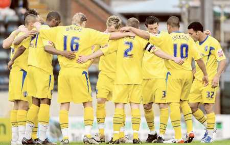 Gills players in a pre-match huddle at Rochdale