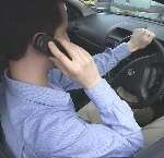 Using hand-held mobile phones while driving has been illegal since December 2003