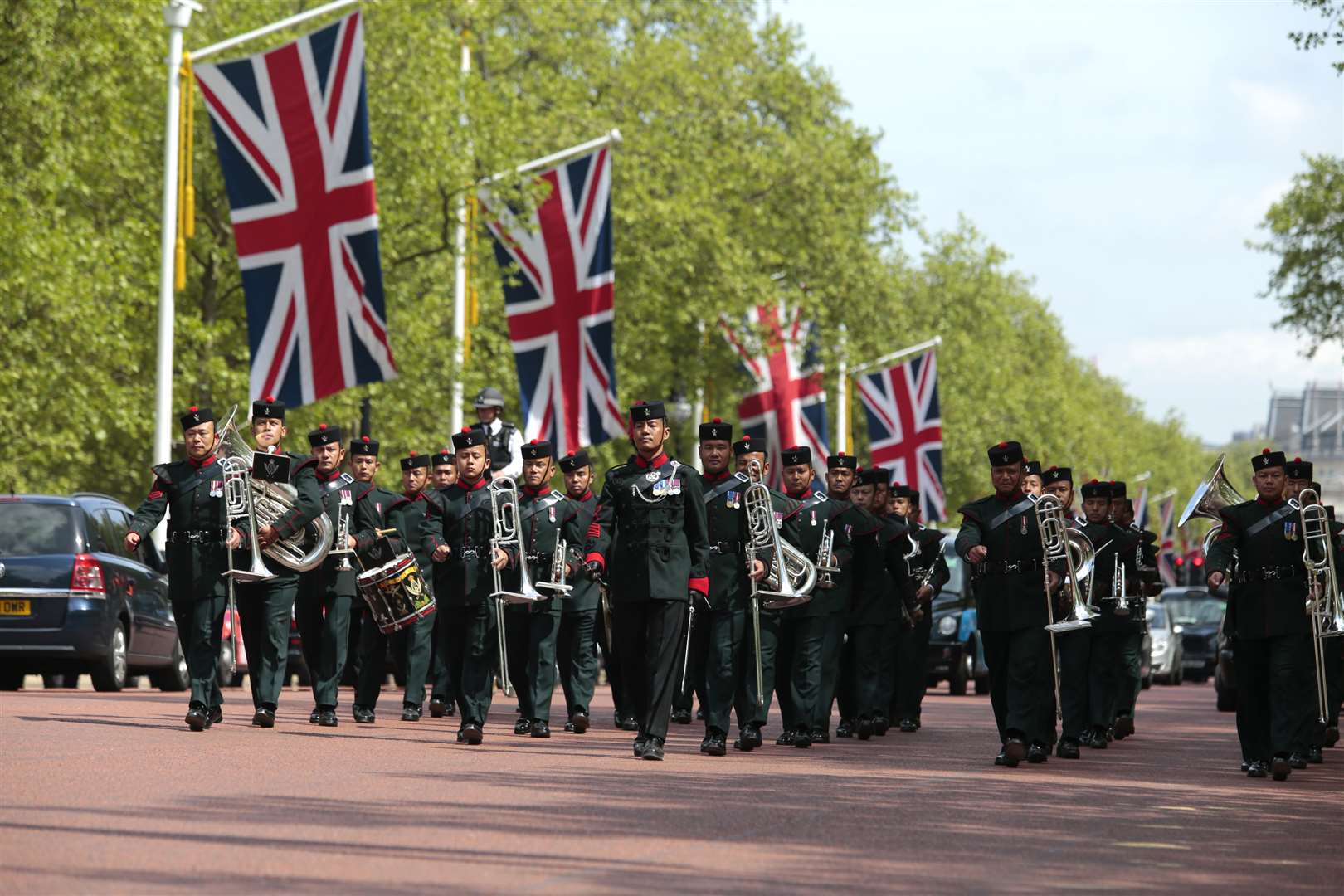 The Band of the Brigade of Gurkhas march up the Mall towards Buckingham Palace. Picture: Martin Apps