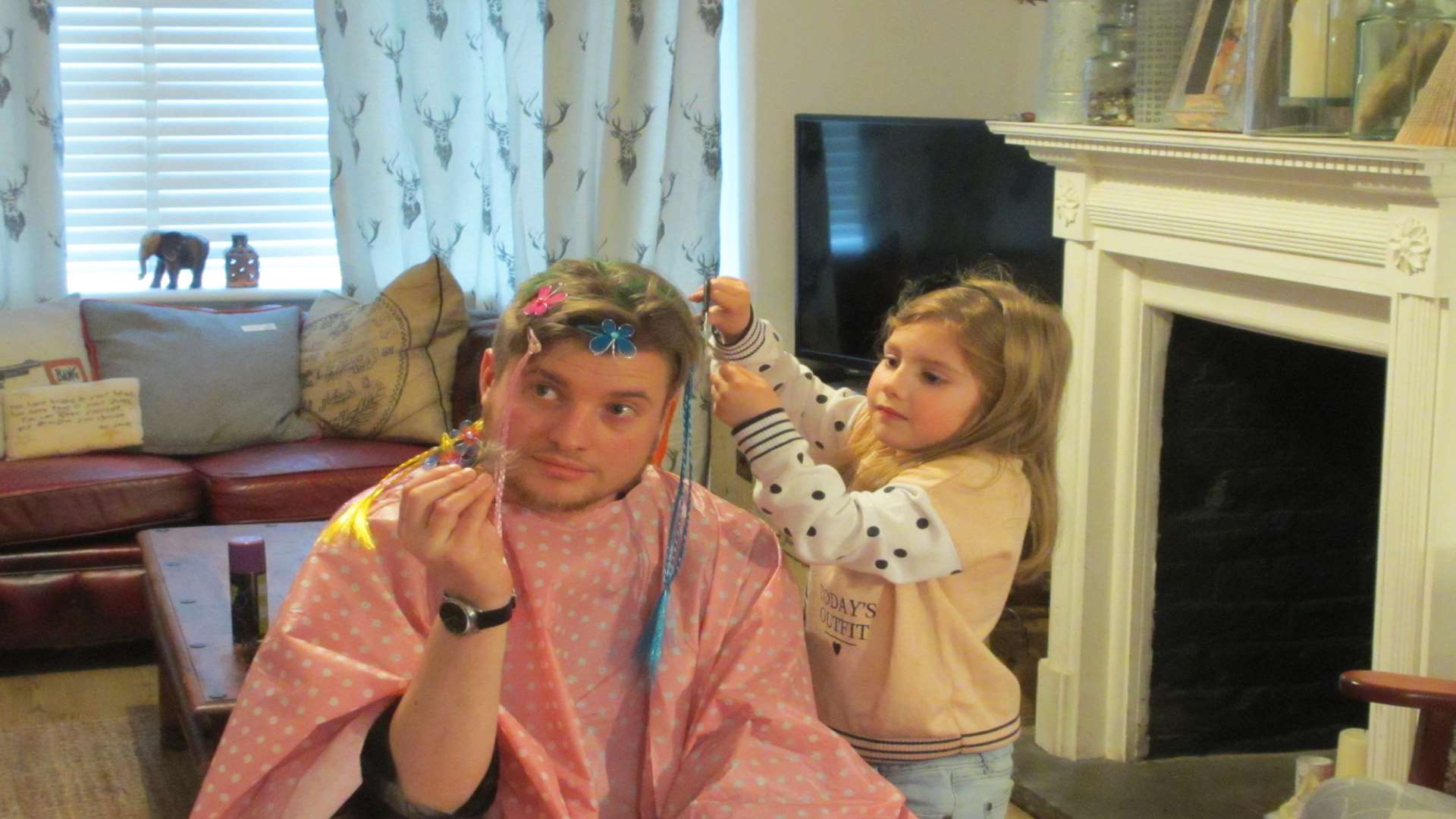 Barney watches on as niece Evelyn gets to work on his new do