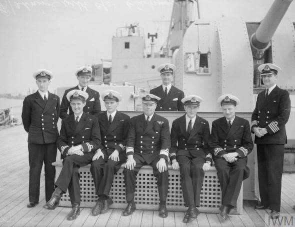 Submarine commanders on the foredeck of HMS Maidstone with Rear Admiral Claud Barrington Barry, centre, and Maidstone's Captain, "Barney" Fawkes, on the far right, probably taken in 1943