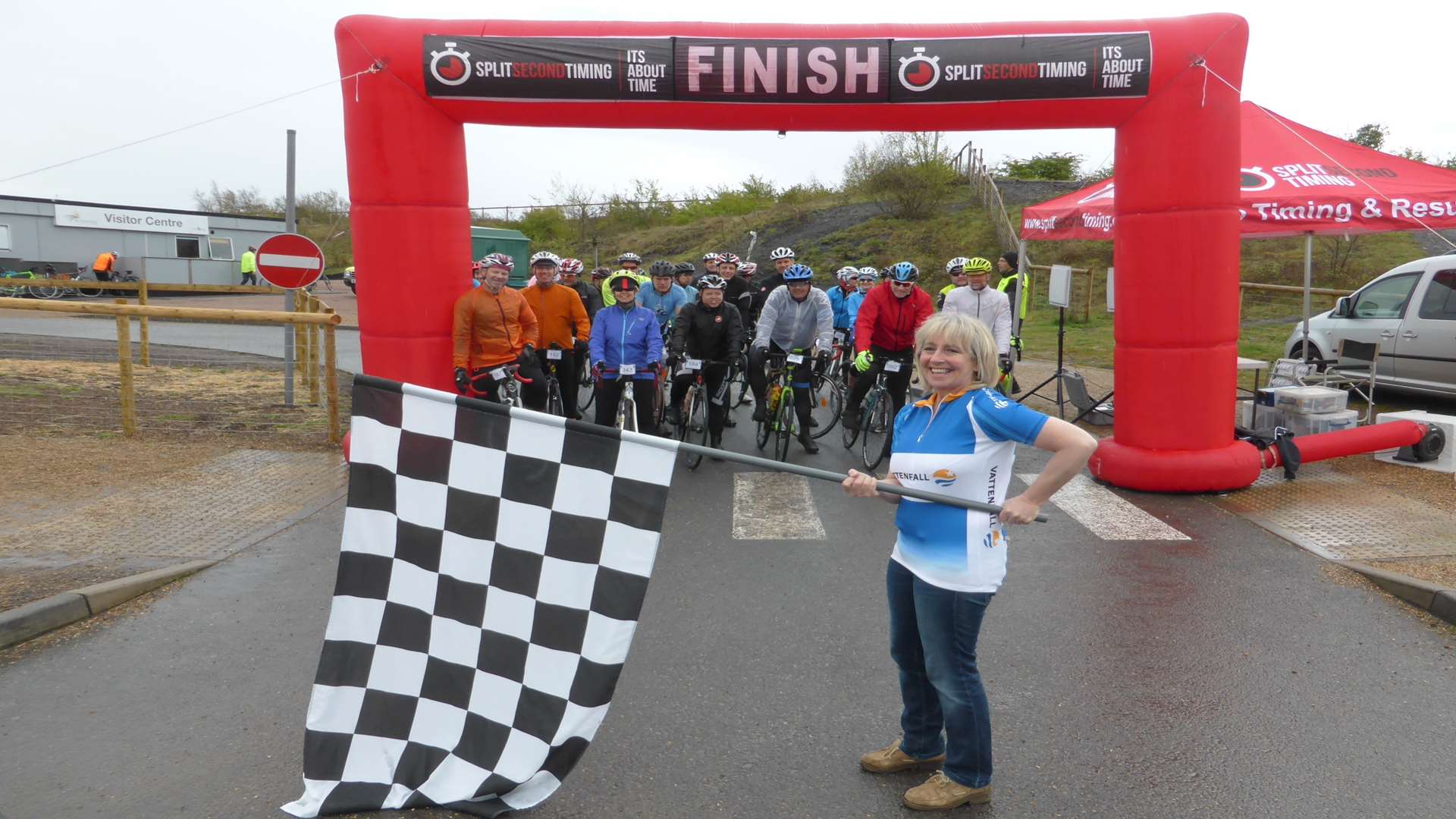 Melanie Rogers from Vattenfall Wind and Power Ltd waves the chequered flag to formally start the ride. The KM Big Bike Ride attracted 370 riders taking part in either the 50km or 100km routes. Riders could take part for fun or for charity. £17k was raised for good causes.