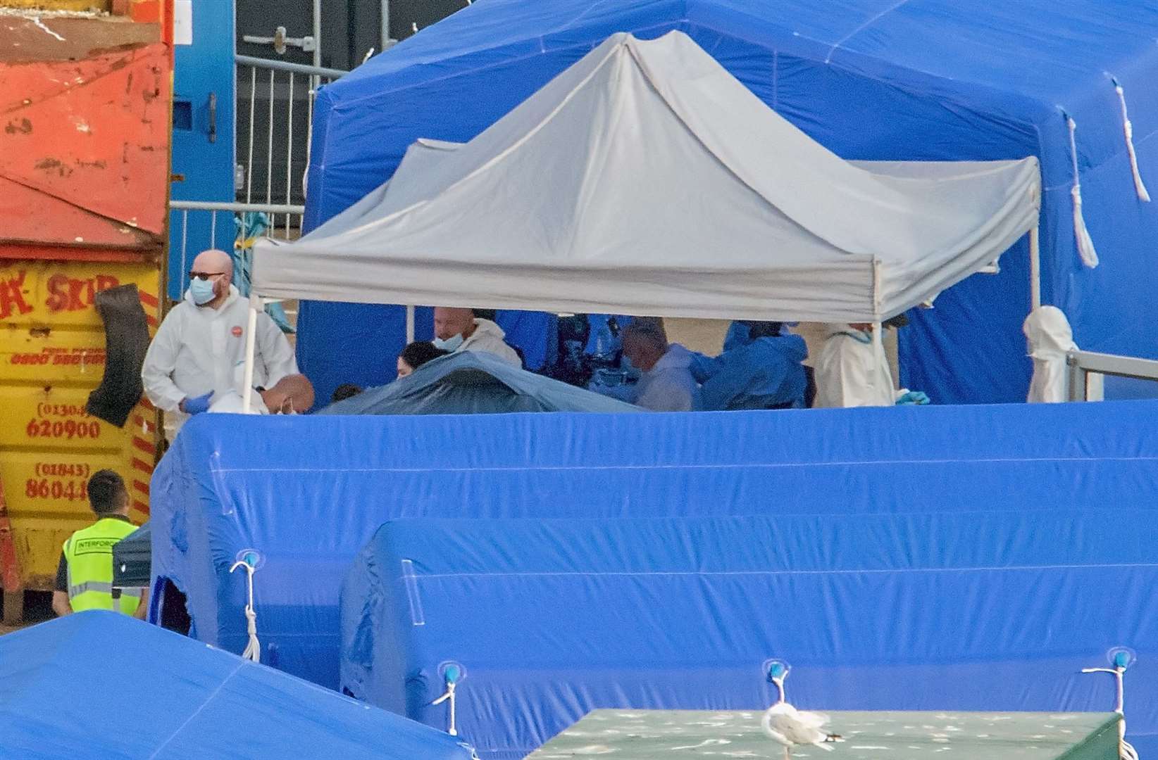 Staff were seen wearing protective biohazard suits and face masks. Credit: Stuart Brock